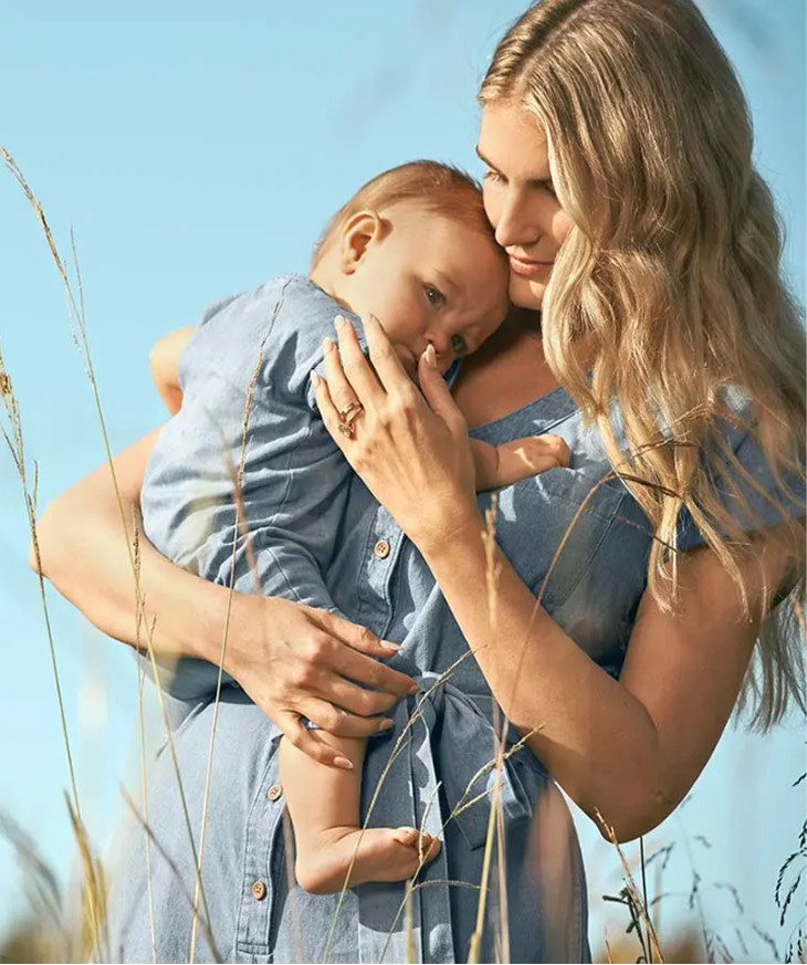 Mother holding child outdoors