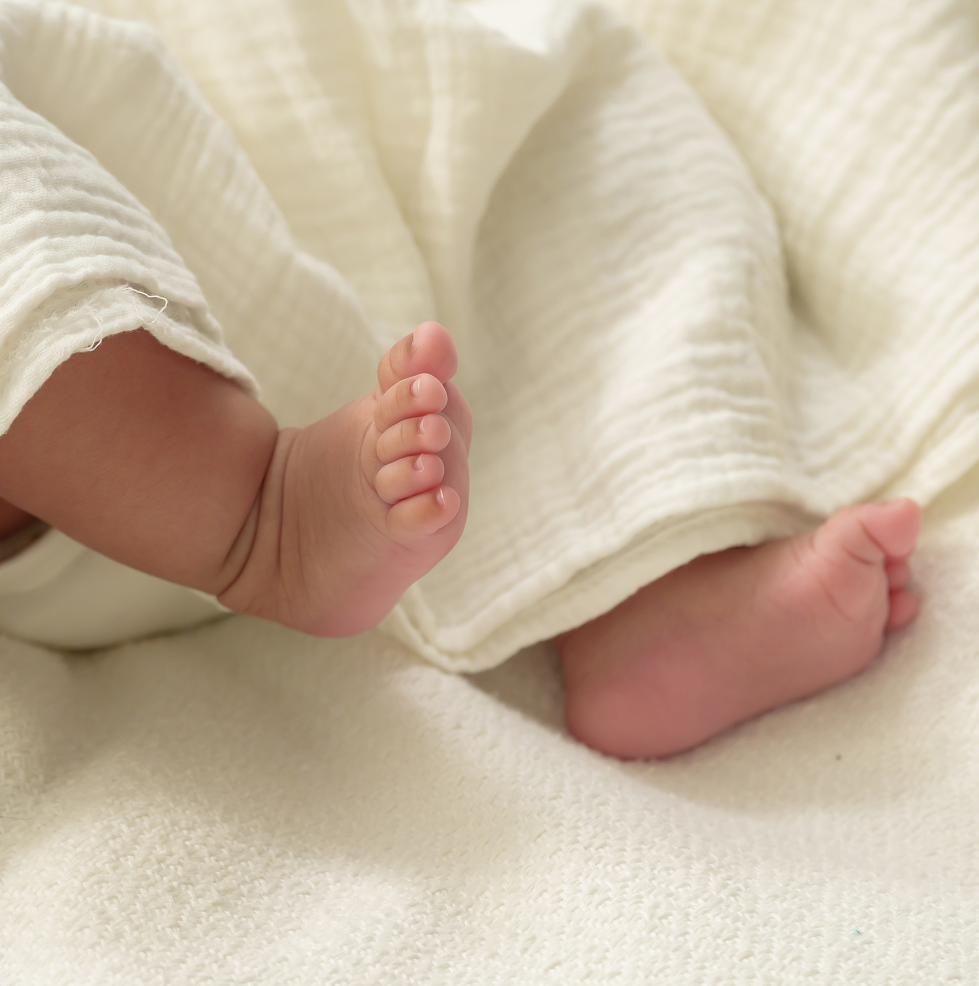 Baby feet on soft organic fabric